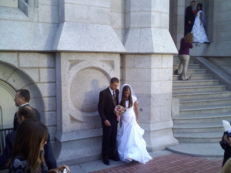 Bride and groom walking outside the temple on their wedding day